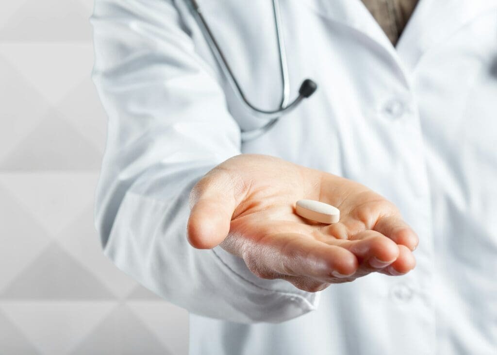 Doctor holding pills